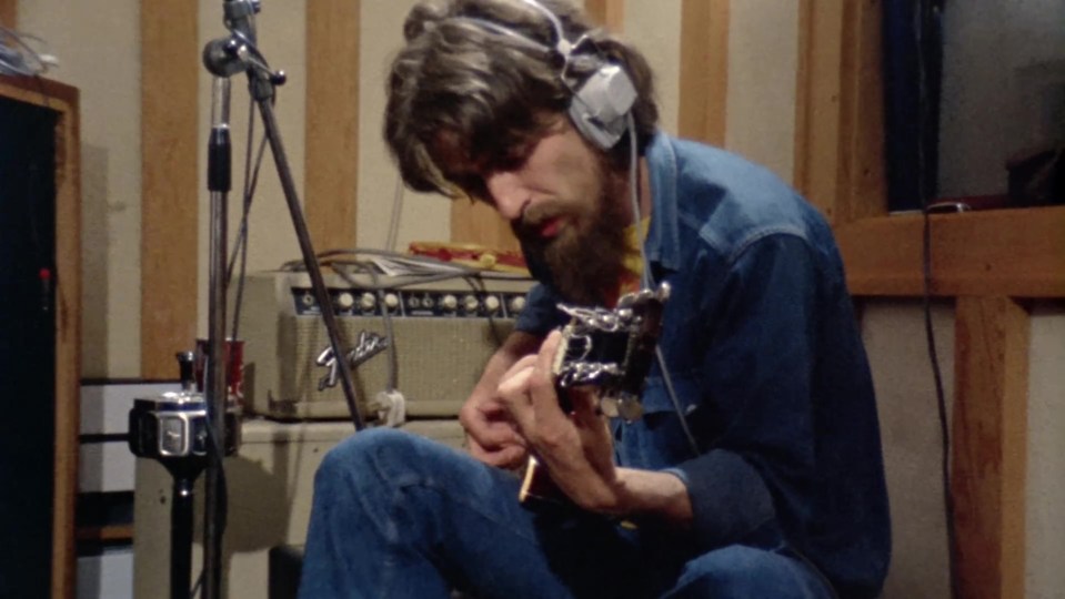 George Harrison playing guitar in the studio