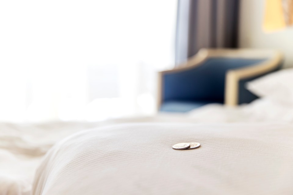 Kerry thinks it is best to leave some coins on the bed as a tip for housekeeping staff in your hotel