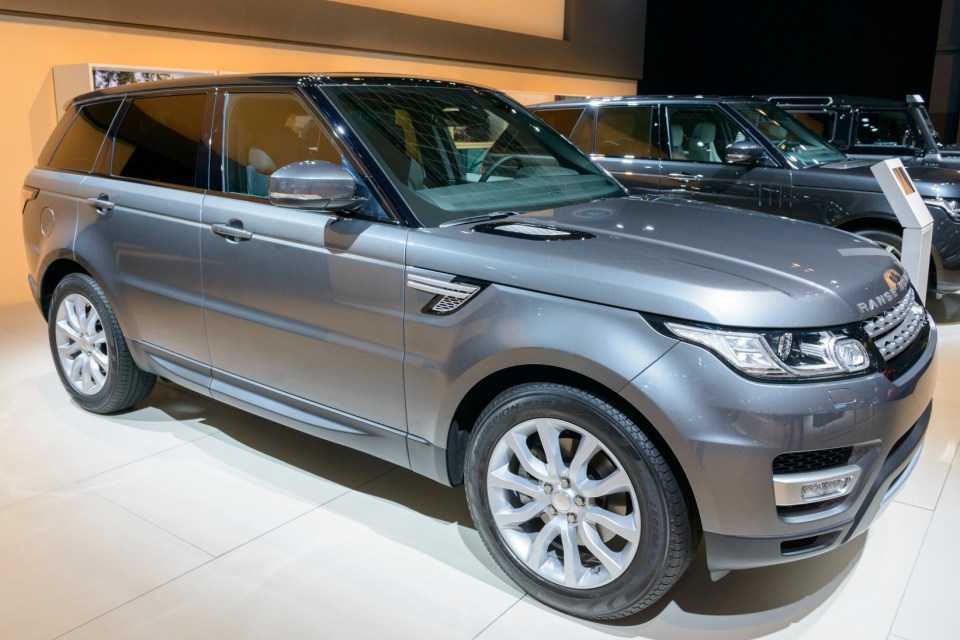 Brussels, Belgium - January 15, 2015: Range Rover Sport SUV on display during the 2015 Brussels motor show. People in the background are looking at the cars.