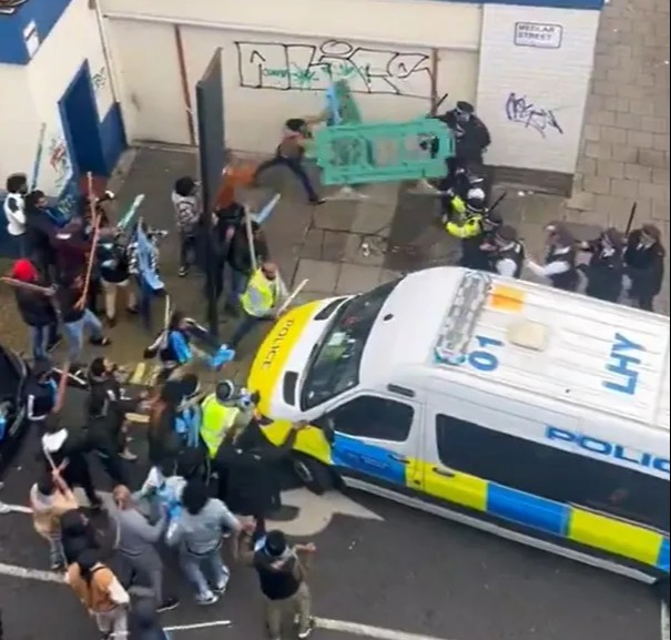 Protesters were seen throwing barriers at police amid the chaos in Camberwell