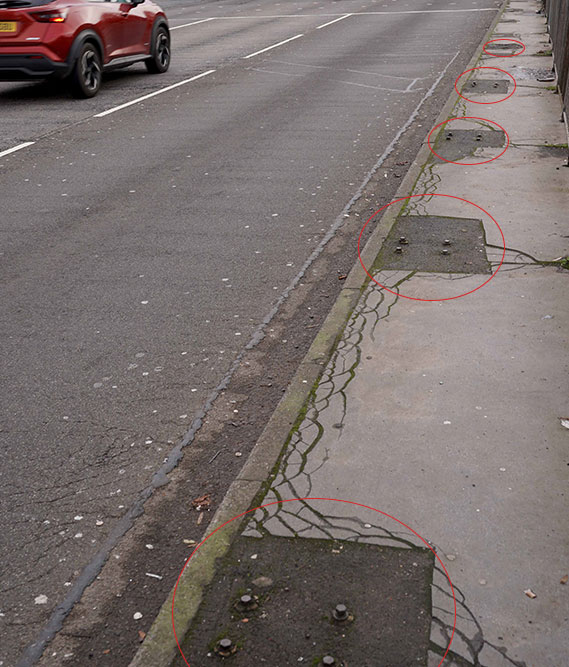 The old nuts and bolts that were once used to hold safety barriers in place are still visible