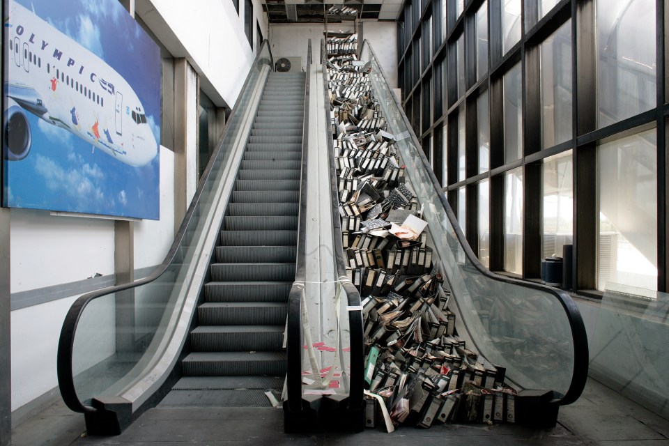 An internal view of the airport where one of the escalators is blocked up