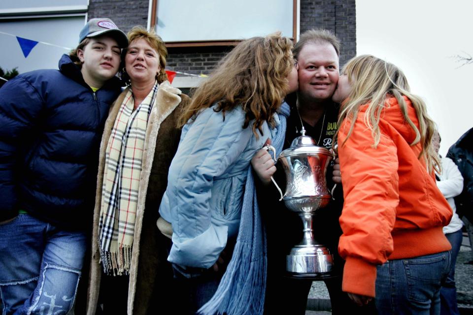 The player is congratulated by Silvia and the three kids after winning the World Darts Council’s title