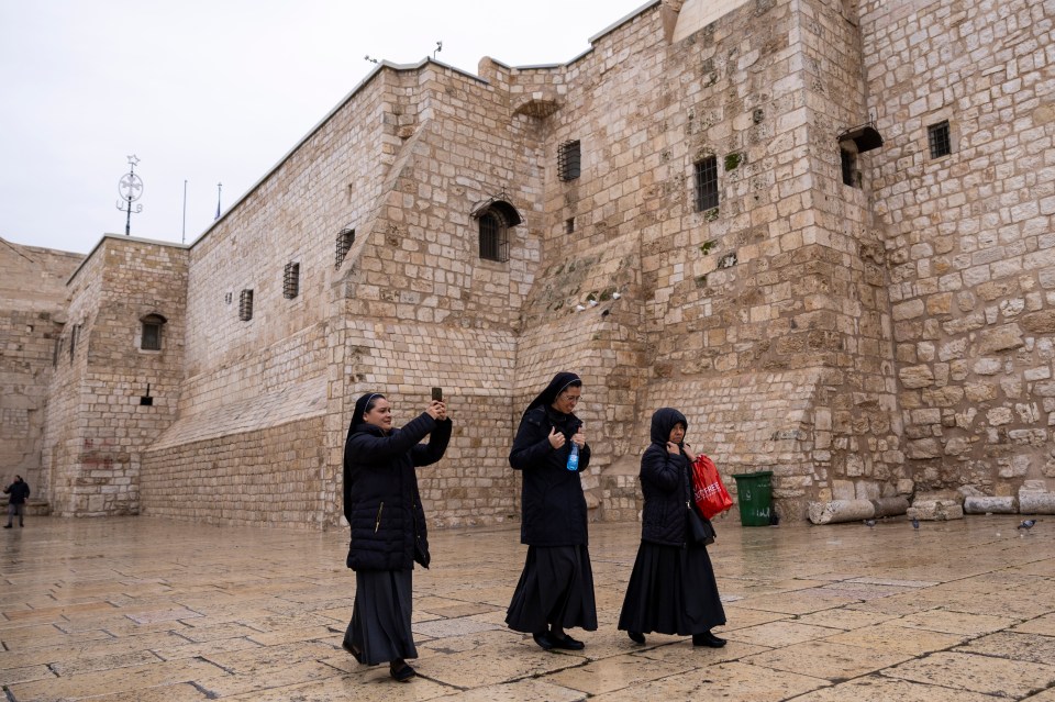 Nuns leave Mass on Christmas Eve through a deserted square