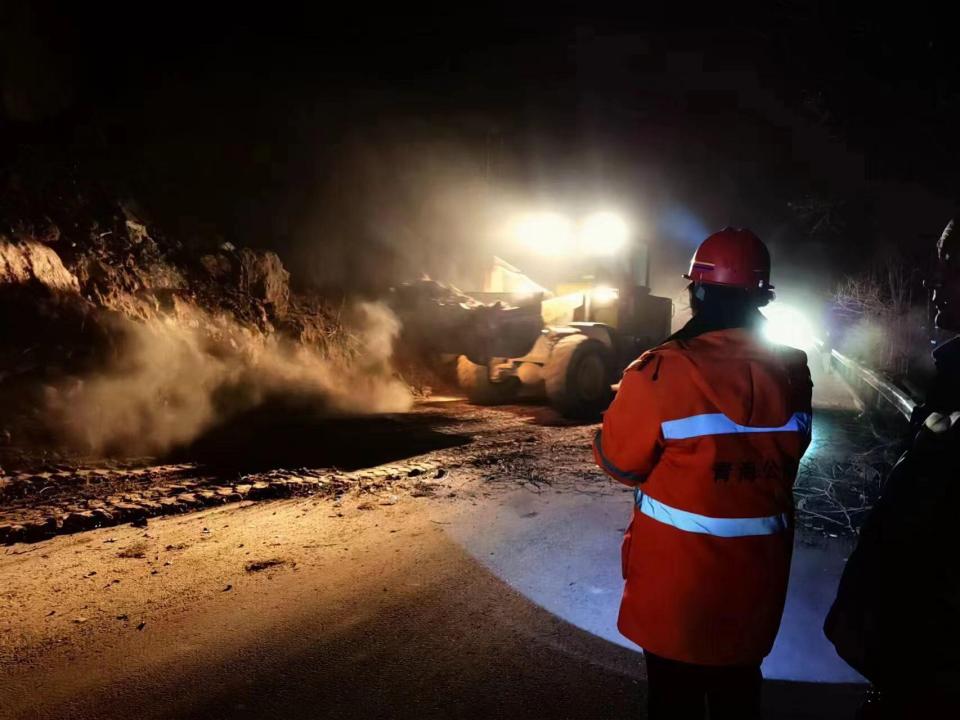 Workers try to fix a road damaged by the earthquake in Haidong, Qinghai province