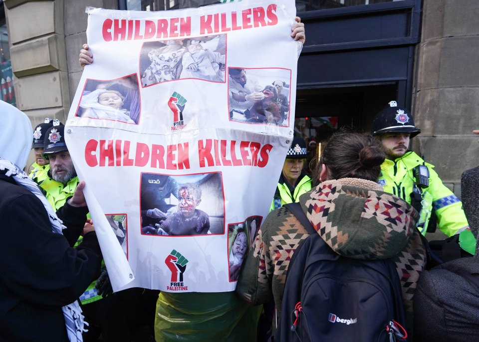 Placards reading 'child killers' were waved in officers' faces