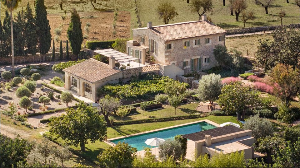 a large house with a swimming pool in front of it