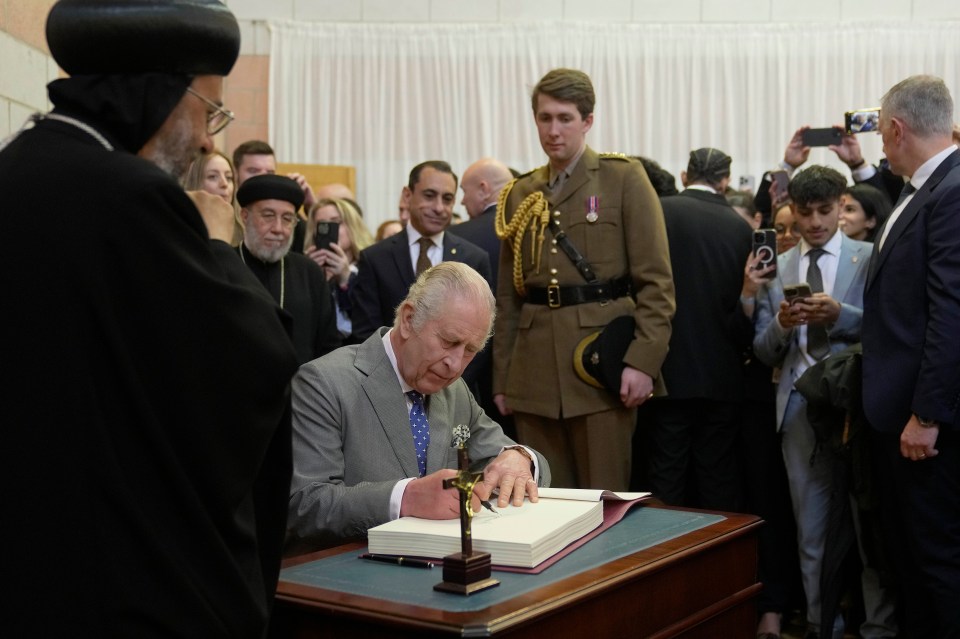 The monarch signed a book as he enjoyed the festive service