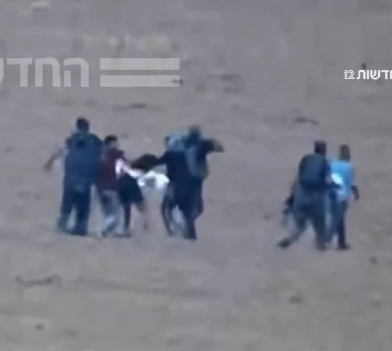 The video shows Hamas fighters violently dragging Amit into Gaza