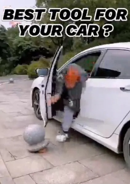 The YouTuber opens the car door only for it to hit a bollard