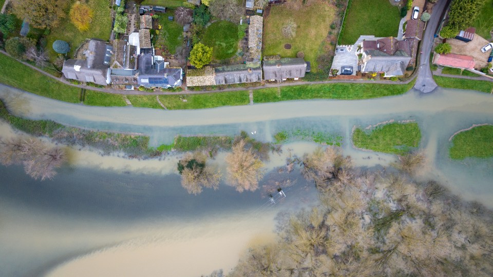 Flooding down the High Street and the surrounding fields in the village of Holywell in Cambridgeshire on Sunday morning after the River Great Ouse burst its banks