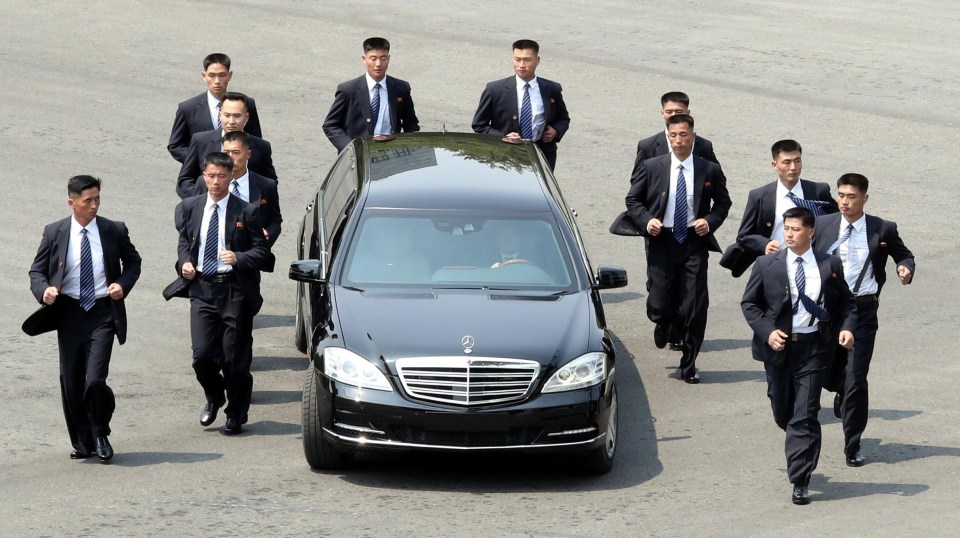 The North Korean dictator was flaked on all sides as he was driven off for lunch