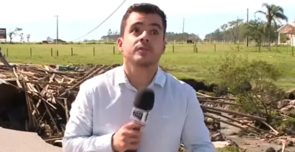 The reporter noticed the pole and cables above him start to come down