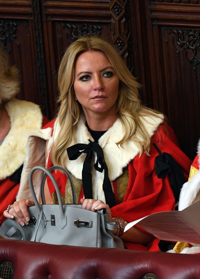 Baroness Michelle Mone (C) waits for the start of the State Opening of Parliament in the Houses of Parliament in London on June 21, 2017. 
Queen Elizabeth II will formally open parliament and announce the British government's legislative programme on Wednesday, two days later than planned. The state opening, a ceremony full of pomp in which the monarch reads out the Queen's Speech detailing the government's programme for the coming year, was due to take place on June 19, but was delayed after Britain's Prime Minister Theresa May's Conservative party lost their majority in the House of Commons in the June 8 election. / AFP PHOTO / POOL / Stefan Rousseau        (Photo credit should read STEFAN ROUSSEAU/AFP via Getty Images)