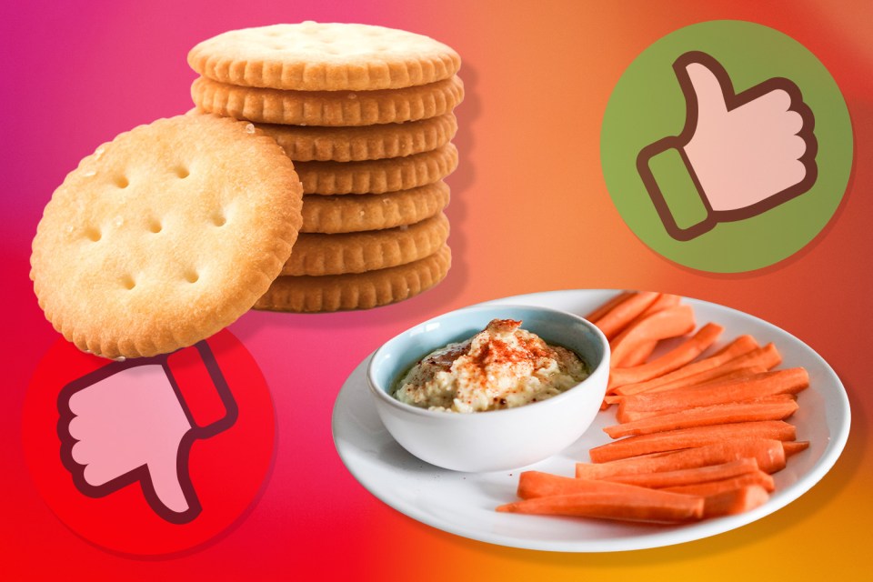 a stack of crackers next to a bowl of hummus and carrots