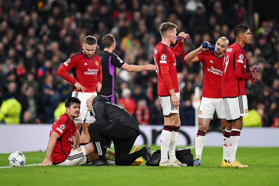 MANCHESTER, ENGLAND - DECEMBER 12: Harry Maguire of Manchester United receives medical treatment to an injury during the UEFA Champions League match between Manchester United and FC Bayern München at Old Trafford on December 12, 2023 in Manchester, England. (Photo by Shaun Botterill/Getty Images)