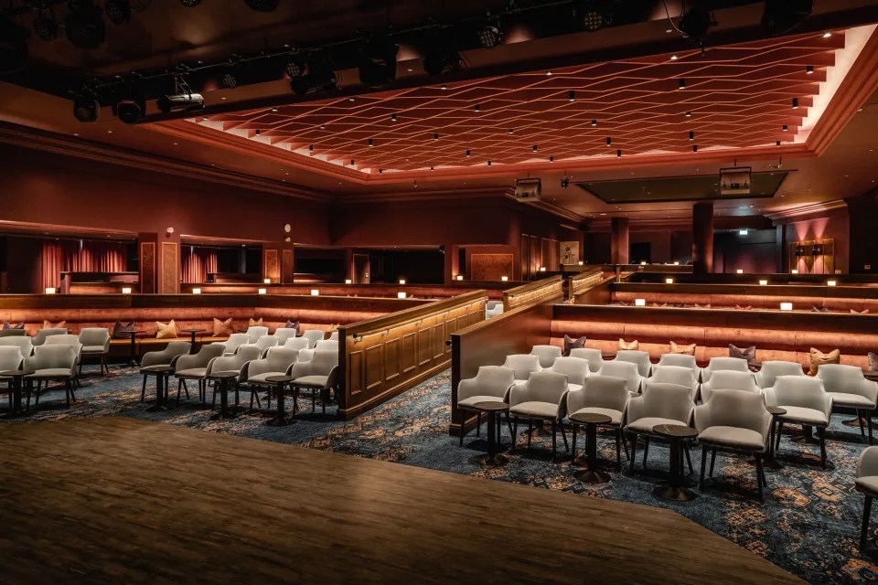 a large auditorium with rows of chairs and tables