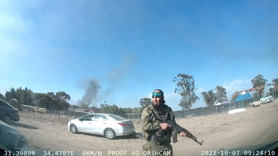 A grab from a UGC video posted on Telegram on October 9, 2023, shows an armed Palestinian militant walking around the Supernova music festival, near Kibbutz Reim in the Negev desert in southern Israel. Hamas gunmen killed around 250 people who attended an outdoor music festival in an Israeli community near Gaza at the weekend, a volunteer who helped collect the bodies said on Monday. (Photo by ANONYMOUS / AFP) / RESTRICTED TO EDITORIAL USE MANDATORY CREDIT « AFP PHOTO / ANONYMOUS » - NO MARKETING NO ADVERTISING CAMPAIGNS NO RESALE DISTRIBUTED AS A SERVICE TO CLIENTS (Photo by -/ANONYMOUS/AFP via Getty Images)