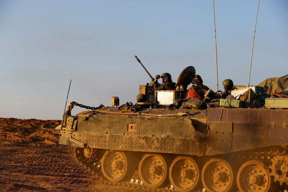 Israeli troops in an armoured personnel carrier move in southern Israel