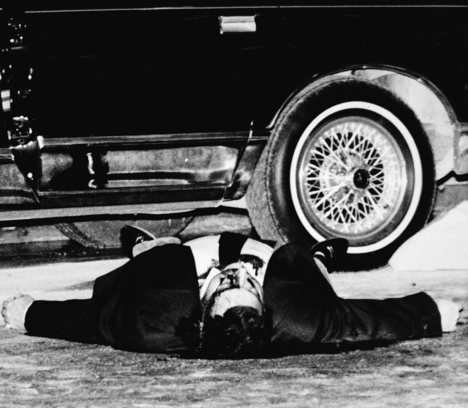 The body of mobster Thomas Bilotti lies on a midtown Manhattan street next to the car he was driving in New York City in 1985