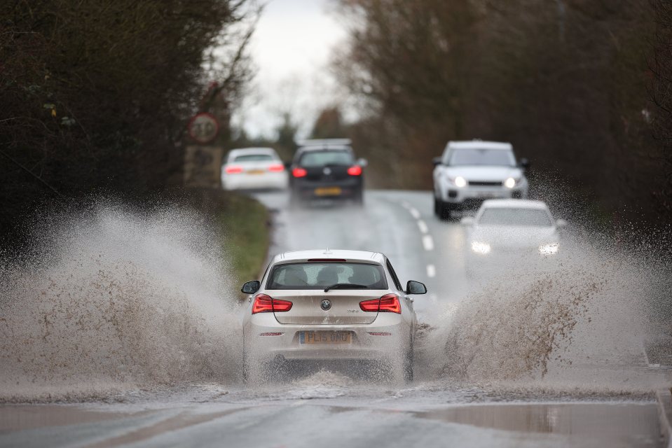 Cars make their way through a flooded road in Wolverhampton