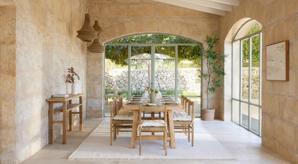 a dining room with a table and chairs and a picture on the wall