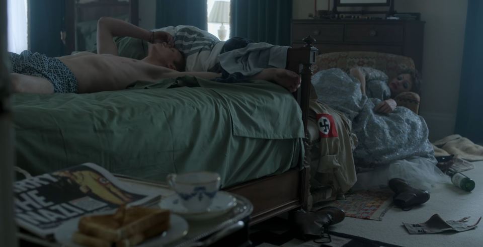 Prince Harry in bed with the newspaper and Nazi uniform in the scene