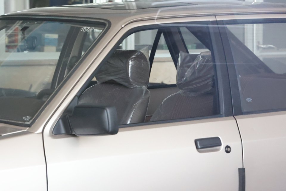 The car seats are still wrapped in plastic and sales stickers on the side advertise the motors as new