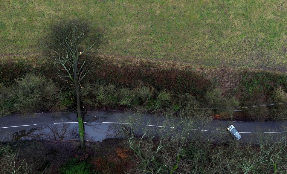 A fallen tree blocks the road on Three Mile Lane in Keele, Staffordshire