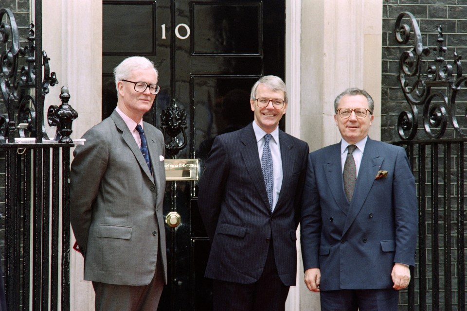 Then Prime Minister John Major, centre, and Foreign Secretary Douglas Hurd, left, welcome Jacques Delors, outside Downing Street on July 1, 1992