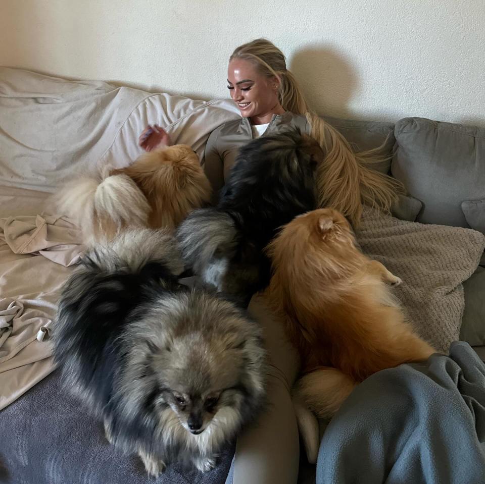 One snap showed her sharing a bed with her cute dogs