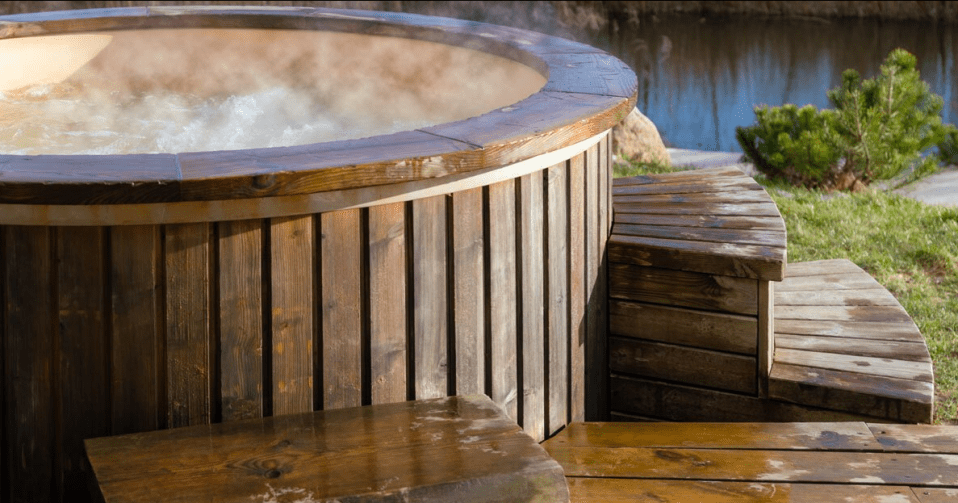 a wooden hot tub with steam coming out of it