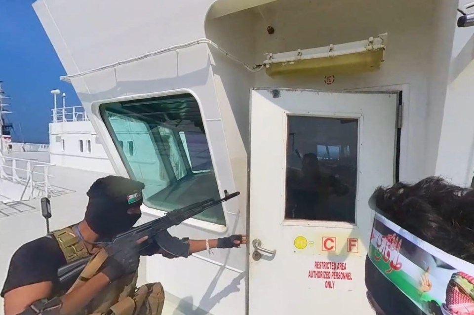 A Houthi gunman storming a ship in the Red Sea in November