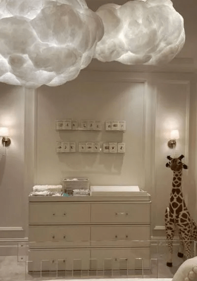 The room is decorated in cream neutral tones and the cloud modern acrylic crib is worth £5,000