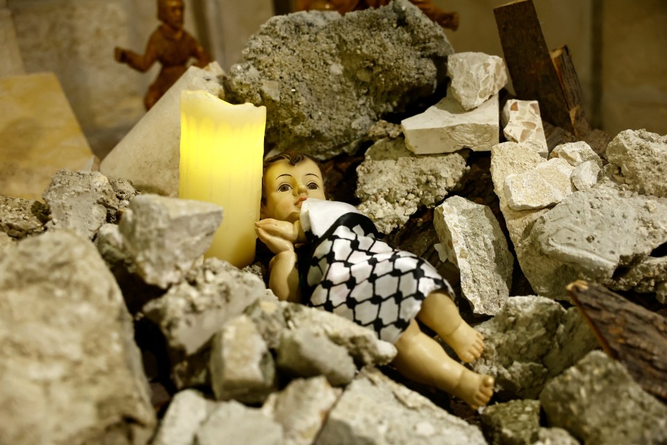 Baby Jesus lying amidst the rubble in a grotto - instead of the usual nativity display