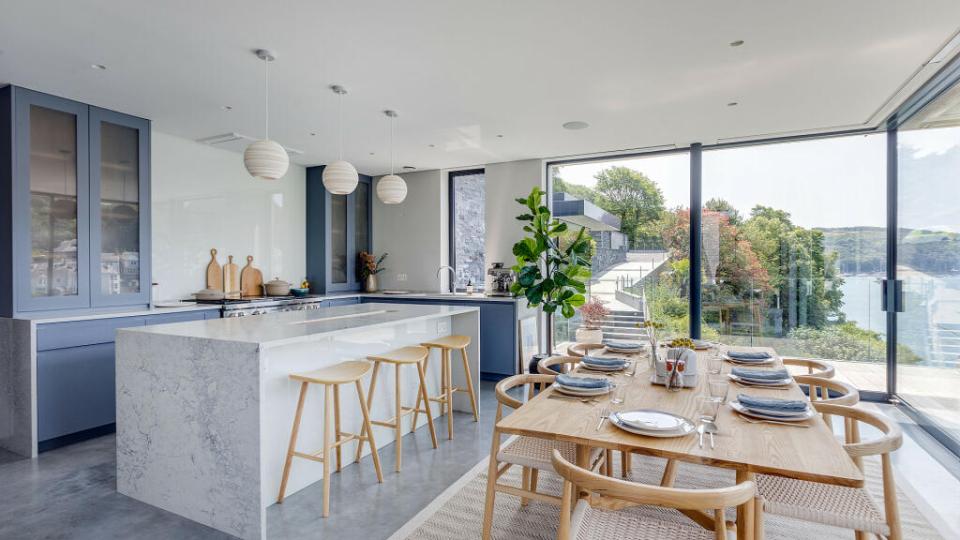 a kitchen and dining room with a view of the ocean