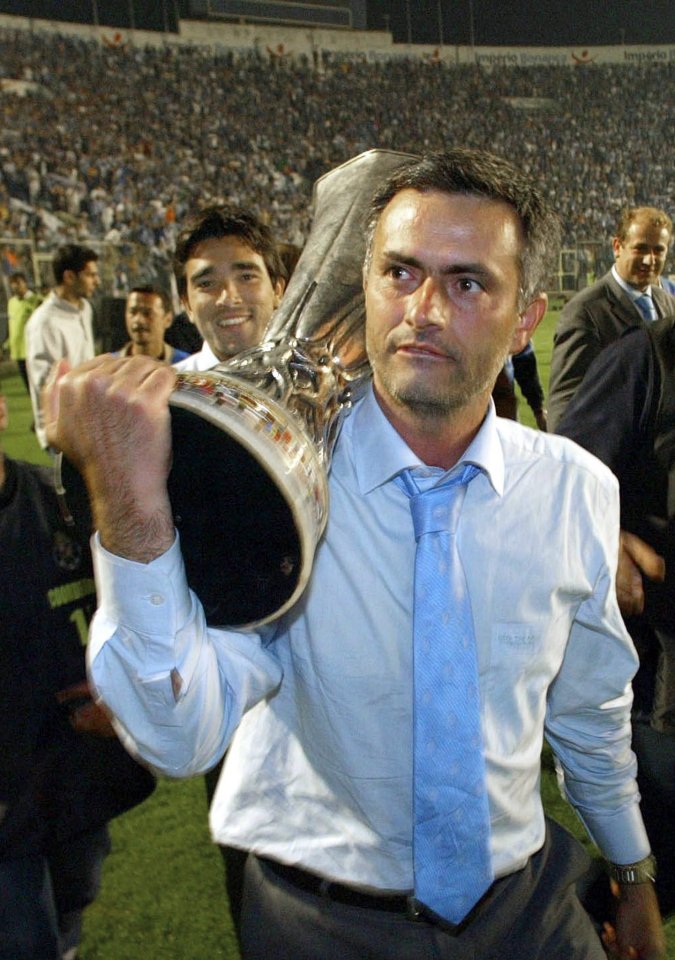 Mourinho carries the Uefa Cup after leading Porto to glory in his first full season