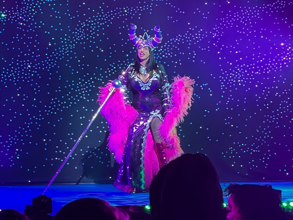 Her purple gown featured a revealing thigh-high split with pink fur sleeves