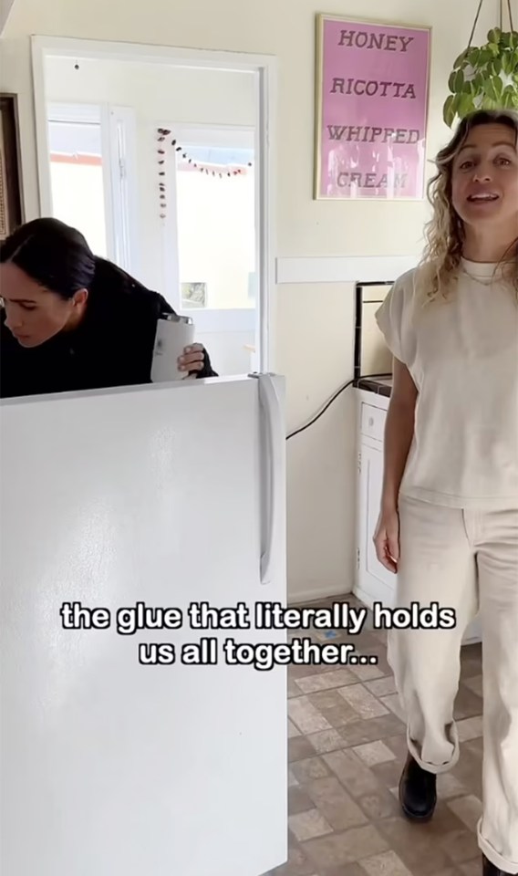 Meghan can be seen handing a coffee to boss Hannah Mendoza in the video