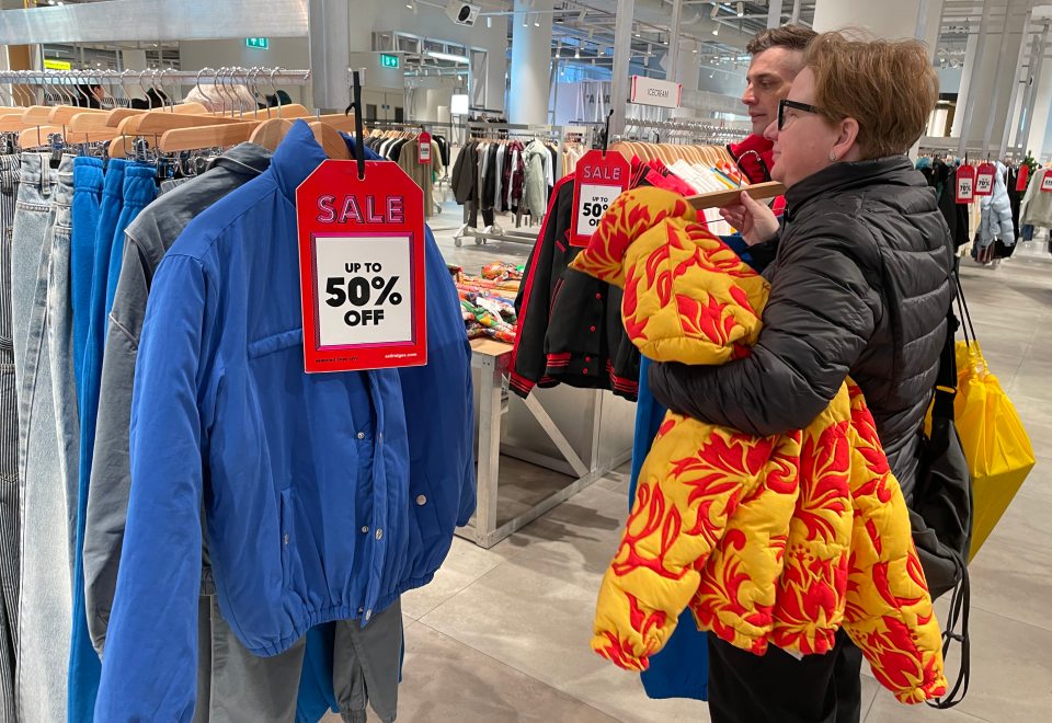 Shoppers in Selfirdges, London, raid the rails for a clothes bargain