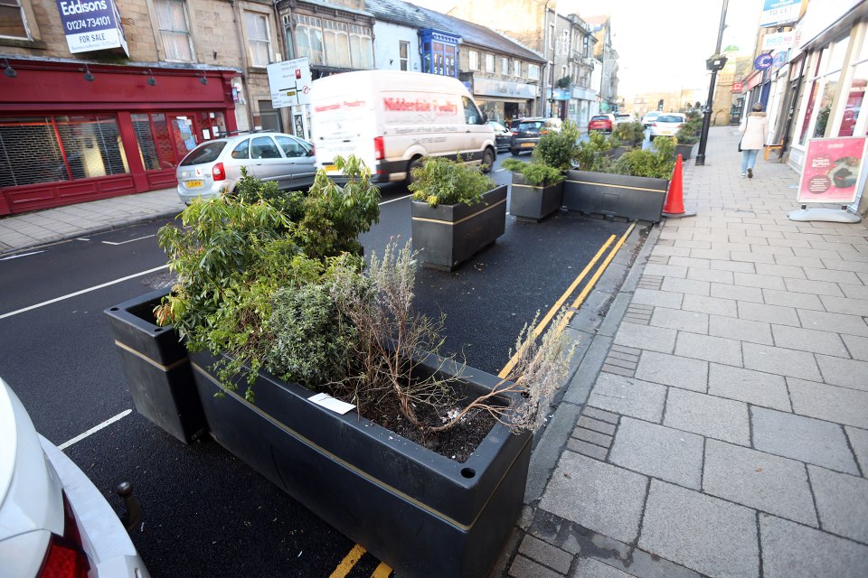 The planters, pictured lining the high street in Otley, were installed during the Covid pandemic