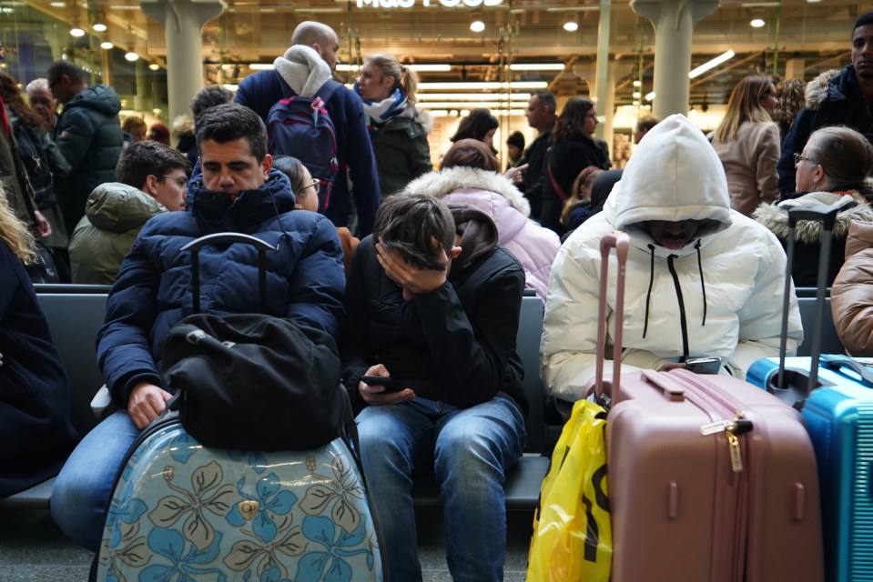 Fed-up passengers waiting on the concourse at the entrance to Eurostar in St Pancras International station