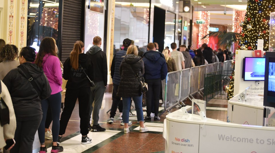 Long queues snake through the Trafford Centre in Manchester this morning