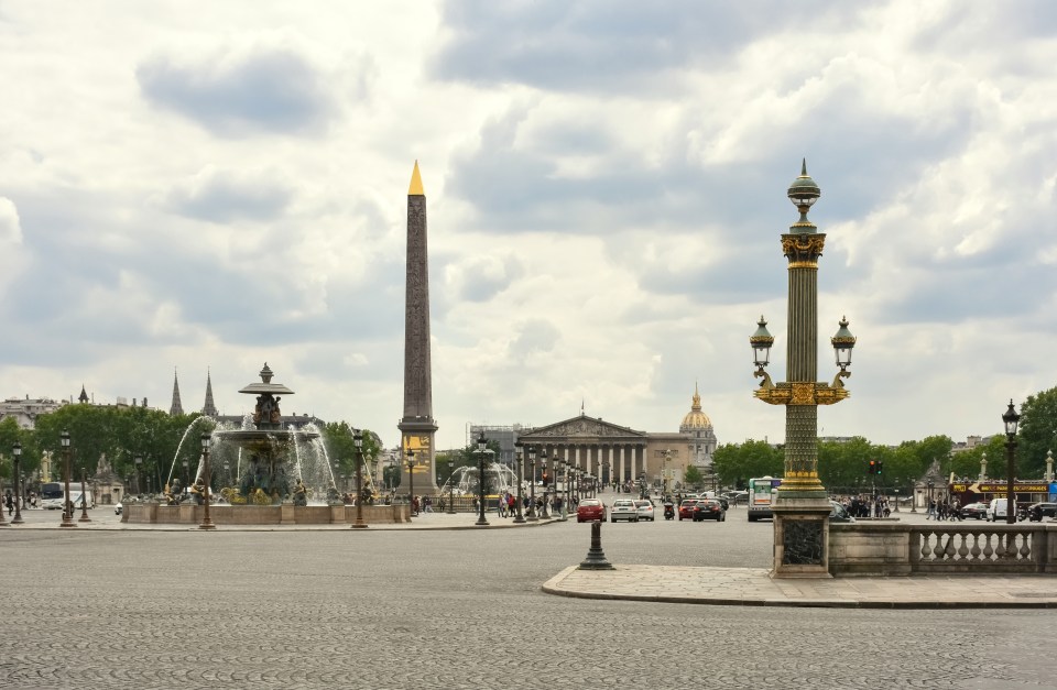 Place de la Concorde in Paris with Obelisk of Luxor, National Assembly facade and Hotel des Invalides on the background in Paris, Ile de France, France, a UNESCO heritage site