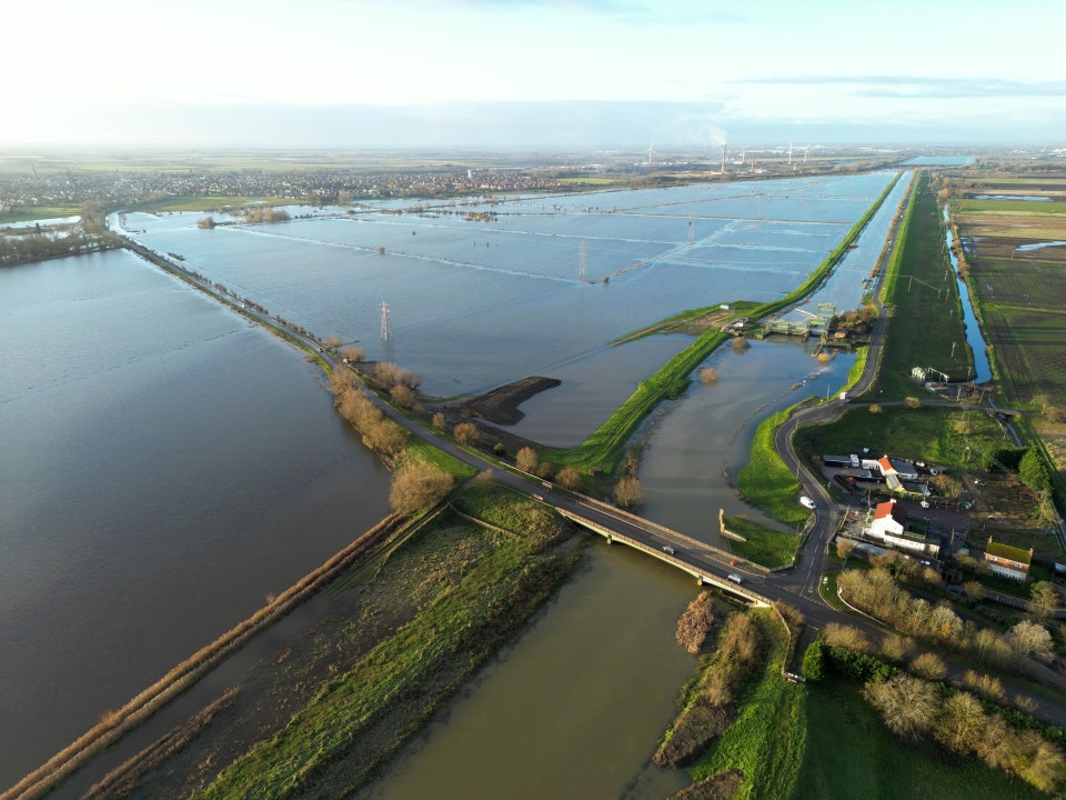 The River Nene near the Dog in a Doublet sluice has breached its banks near Cambridgeshire today