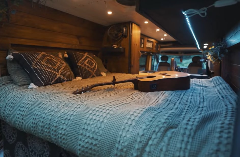 The van has a separate bedroom with a full-sized bed