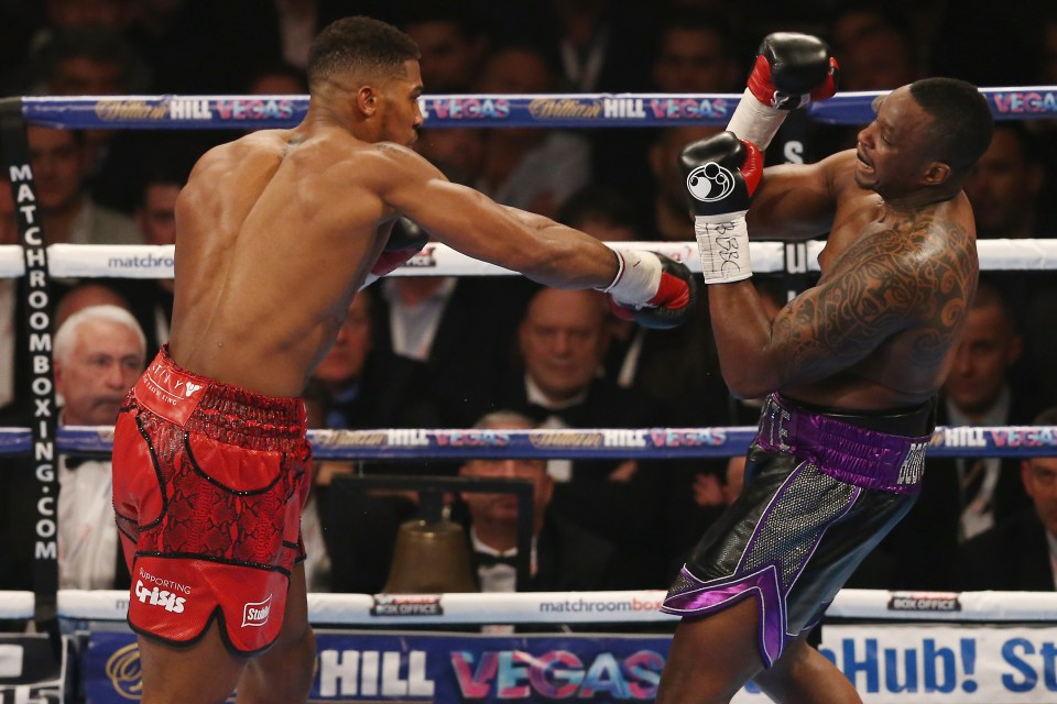 two boxers in a ring with a hill vegas ad in the background