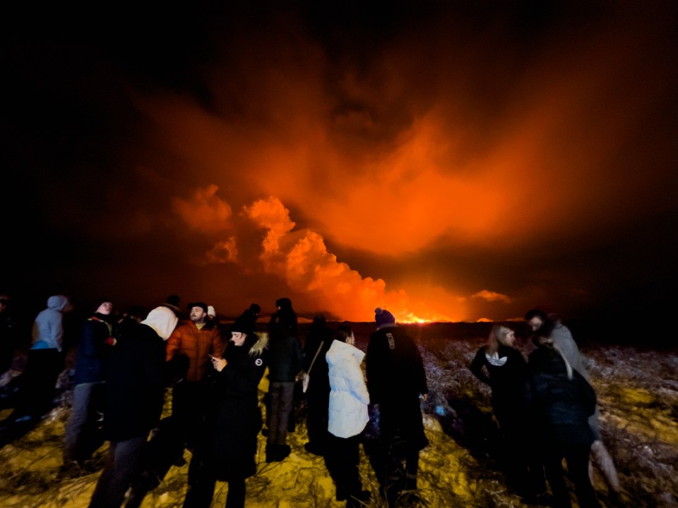 People crowd around to watch the eruption