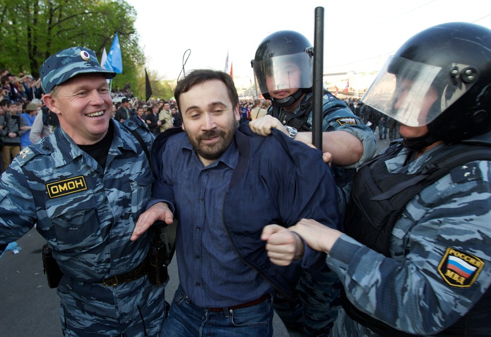 The exiled opposition leader being escorted out of Bolotnaya square in Moscow in 2012