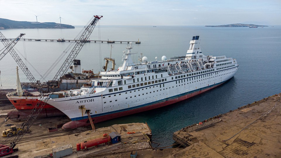 The MS Astor floats in a graveyard full of abandoned ships